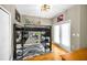 Bedroom showcasing a creative loft bed with desk, complemented by natural light from the French doors at 10035 New Parke Rd, Tampa, FL 33626