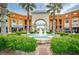 Beautiful community fountain framed by palm trees and commercial buildings, showcasing a tranquil outdoor space at 10035 New Parke Rd, Tampa, FL 33626