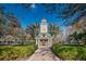 Picturesque community landmark with manicured hedges, brick pathway, and inviting architecture at 10035 New Parke Rd, Tampa, FL 33626