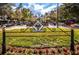 Scenic community space with lush landscaping, seating, and a welcoming village plaza sign at 10035 New Parke Rd, Tampa, FL 33626