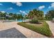 Beautiful community pool and landscaped area on a sunny day with blue skies and scattered clouds at 10035 New Parke Rd, Tampa, FL 33626
