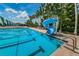 Community pool with a waterslide, palm trees, and lounge chairs for a resort-style living experience at 10035 New Parke Rd, Tampa, FL 33626