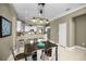 Open dining area with a view of the kitchen featuring a modern light fixture at 10035 New Parke Rd, Tampa, FL 33626