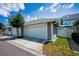 Detached one-car garage features a driveway, landscaping, and convenient access to the property at 10035 New Parke Rd, Tampa, FL 33626