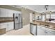 Bright kitchen with stainless steel appliances, granite counters, and white cabinets at 10035 New Parke Rd, Tampa, FL 33626