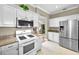 Modern kitchen with stainless steel fridge, white cabinets and stove at 10035 New Parke Rd, Tampa, FL 33626
