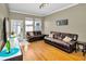Cozy living room with wood floors, comfortable leather sofas, and a view of the backyard at 10035 New Parke Rd, Tampa, FL 33626