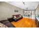 Open-concept living area with wood floors, comfortable sofa and views of the kitchen at 10035 New Parke Rd, Tampa, FL 33626