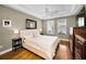 Comfortable main bedroom boasts tray ceiling, hardwood floors, and two windows for natural light at 10035 New Parke Rd, Tampa, FL 33626