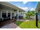 Serene covered patio with brick flooring, comfortable seating, and views of the well-manicured backyard at 10035 New Parke Rd, Tampa, FL 33626