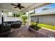 Charming covered patio featuring comfortable seating, brick flooring, and a serene outdoor space at 10035 New Parke Rd, Tampa, FL 33626