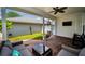 Inviting covered patio with brick flooring, a lounge area, and a hanging chair, perfect for outdoor relaxation at 10035 New Parke Rd, Tampa, FL 33626