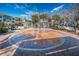 Community splash pad with a circular design, surrounded by a brick patio and lush greenery at 10035 New Parke Rd, Tampa, FL 33626