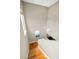 An interior staircase features hardwood steps and a modern, minimalist design, complemented by neutral wall tones at 10035 New Parke Rd, Tampa, FL 33626
