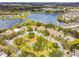 Aerial view of a community featuring residences, landscaping, a playground, and a scenic lake at 10229 Waterside Oaks Dr, Tampa, FL 33647