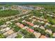 Expansive aerial view of a residential community with lush landscaping, water features, and well-maintained homes in a picturesque setting at 10229 Waterside Oaks Dr, Tampa, FL 33647