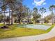 Outdoor basketball court surrounded by lush greenery and palm trees within a residential community at 10229 Waterside Oaks Dr, Tampa, FL 33647