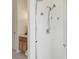 Bright bathroom with tiled shower, safety grab bar, and a shower head at 10229 Waterside Oaks Dr, Tampa, FL 33647