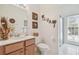 Bright bathroom with neutral tones, tropical decor, and a shower with glass door at 10229 Waterside Oaks Dr, Tampa, FL 33647