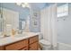 Nautical-themed bathroom with a vanity, a framed mirror, and a shower with a white curtain at 10229 Waterside Oaks Dr, Tampa, FL 33647