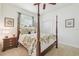 Cozy bedroom features a four-poster bed, side table, and closet at 10229 Waterside Oaks Dr, Tampa, FL 33647