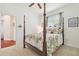 Cozy bedroom features a four-poster bed, side table, and hard wood floors at 10229 Waterside Oaks Dr, Tampa, FL 33647