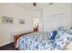 Spacious bedroom featuring a floral comforter and white walls at 10229 Waterside Oaks Dr, Tampa, FL 33647