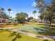 A lovely community park featuring a playground, basketball court and mature trees with lush landscaping at 10229 Waterside Oaks Dr, Tampa, FL 33647