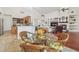 Open concept dining room features hardwood floors and adjacent living area with fireplace at 10229 Waterside Oaks Dr, Tampa, FL 33647