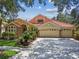Charming home with a three car garage, mature landscaping and a clay tile roof at 10229 Waterside Oaks Dr, Tampa, FL 33647