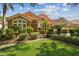 Charming home featuring mature landscaping, a clay tile roof, and a welcoming entrance at 10229 Waterside Oaks Dr, Tampa, FL 33647