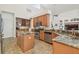 Spacious kitchen boasts an island, granite counters, stainless steel appliances, and a wine rack at 10229 Waterside Oaks Dr, Tampa, FL 33647
