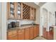 Kitchen features built-in wine rack, granite countertop, and wood cabinets at 10229 Waterside Oaks Dr, Tampa, FL 33647