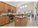 Bright kitchen features granite countertops, stainless steel appliances, island, and tile flooring at 10229 Waterside Oaks Dr, Tampa, FL 33647