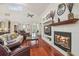 Open-concept living room with hardwood floors, fireplace, and arched doorways for seamless flow at 10229 Waterside Oaks Dr, Tampa, FL 33647