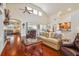 Inviting living room with high ceilings, hardwood floors, and sliding glass doors to a lanai at 10229 Waterside Oaks Dr, Tampa, FL 33647