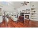 Living room featuring hardwood floors, a fireplace, built-in shelves, and arched doorways at 10229 Waterside Oaks Dr, Tampa, FL 33647