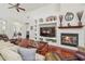 Inviting living room featuring a fireplace, built-in shelves, and hardwood floors for a cozy feel at 10229 Waterside Oaks Dr, Tampa, FL 33647