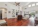Spacious living room featuring high ceilings, ceiling fans, a fireplace, and built-in shelves at 10229 Waterside Oaks Dr, Tampa, FL 33647