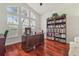 Office with large windows, hardwood floors, and a built in bookcase at 10229 Waterside Oaks Dr, Tampa, FL 33647
