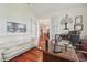 Comfortable office with hardwood floors, white couch, and a view into the home at 10229 Waterside Oaks Dr, Tampa, FL 33647