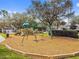 Playground features a variety of equipment including slides and swings on a wood chip surface at 10229 Waterside Oaks Dr, Tampa, FL 33647