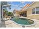 Outdoor private screened in pool area with a travertine tile and a waterfall at 10229 Waterside Oaks Dr, Tampa, FL 33647
