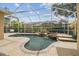 Screened in pool with a waterfall and lots of green landscaping at 10229 Waterside Oaks Dr, Tampa, FL 33647