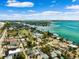 Gorgeous aerial view of a waterfront community with beaches, blue skies, and clear water on a sunny day at 106 13Th Ave, St Pete Beach, FL 33706