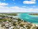 Panoramic aerial view of waterfront community showcasing beaches, blue skies, and a bridge in the background at 106 13Th Ave, St Pete Beach, FL 33706