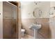 Bathroom with glass-enclosed shower and tiled walls at 106 13Th Ave, St Pete Beach, FL 33706