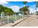Lovely home featuring a white picket fence, tropical landscaping, and neighborhood street view at 106 13Th Ave, St Pete Beach, FL 33706