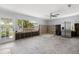 Spacious kitchen under renovation, featuring stainless steel refrigerator and ample natural light from a large window at 106 13Th Ave, St Pete Beach, FL 33706
