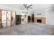 Living room under renovation with a traditional fireplace, ceiling fan, and open layout perfect for customization at 106 13Th Ave, St Pete Beach, FL 33706